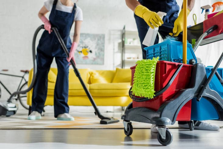 Two StrongHold cleaners with vacuum and supply cart